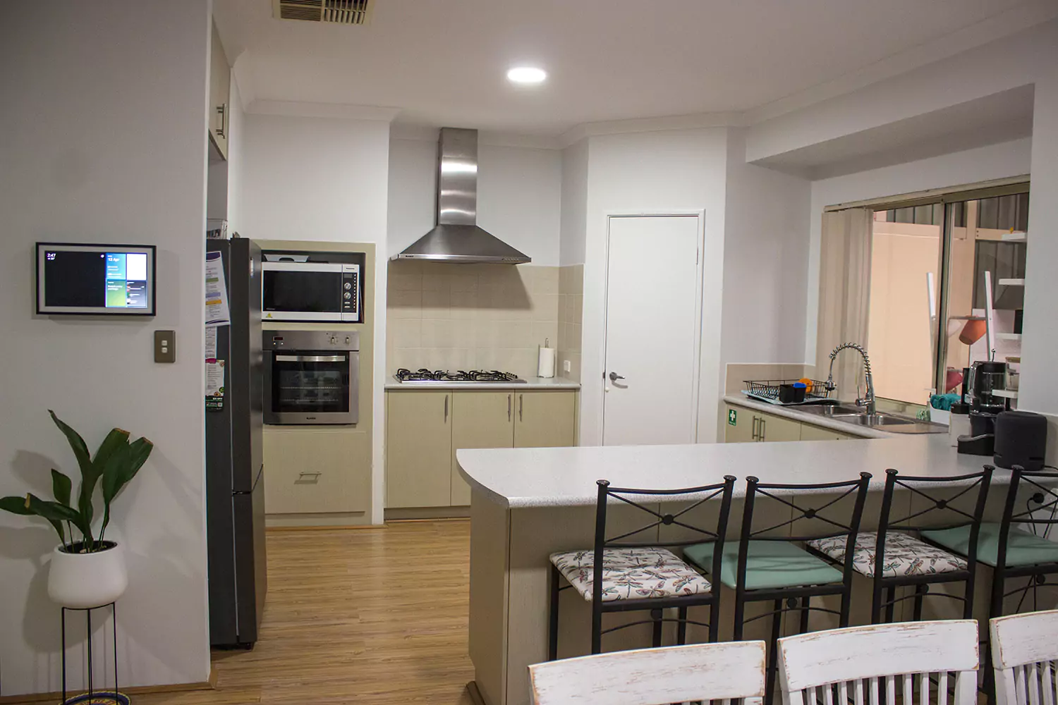 The kitchen of the Sudden Comfort's accommodation. There are comfortable seating options across from the bench, a large clean prep area for cooking and many modern cooking appliances.